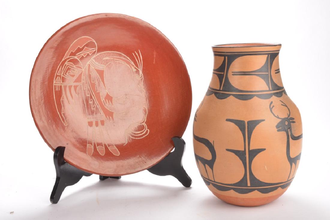 TWO PIECES OF NATIVE AMERICAN POTTERY: A red ware decorated charger, indistinctly signed, 14.5 inches diameter; and pottery vase decorated with stags, signed Susana, 13 inches high