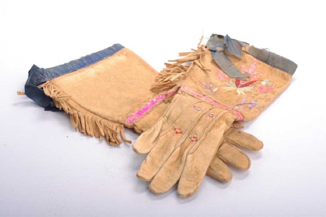 PAIR OF SIOUX QUILLED HIDE GAUNTLETS c. 1890: Embroidered with floral, star and geometric motifs. Silk cuffs. 15 inches.