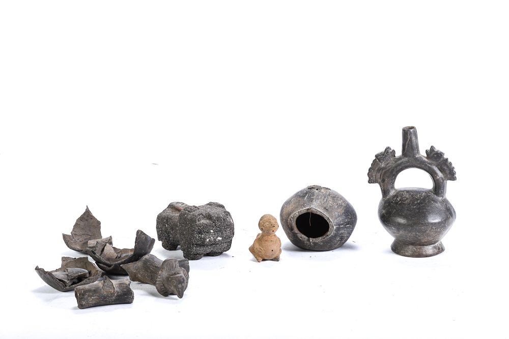 PRE-COLUMBIAN ARTIFACTS: Including: Chimu /Peruvian blackware stirrup vessel, figural redware pipe, carved stone (lava?) effigy and an assortment of blackware shards. 7 inches (and under)