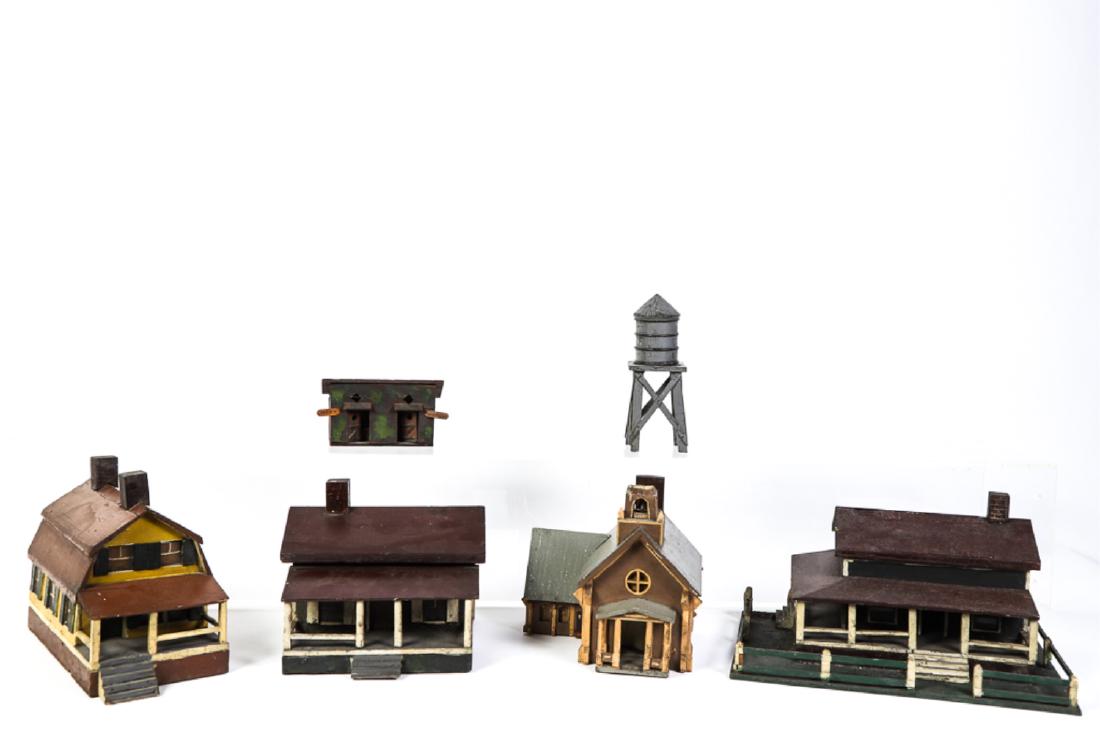 (EARLY 20th c) HAND MADE TRAIN SET ACCESSORIES: Hand carved and painted wood including: Gambrel roofed house, church, outhouse, water tank tower, cottage with porch, and cottage with fenced-in lawn. 9 x 14 x 10 inches ( and smaller)