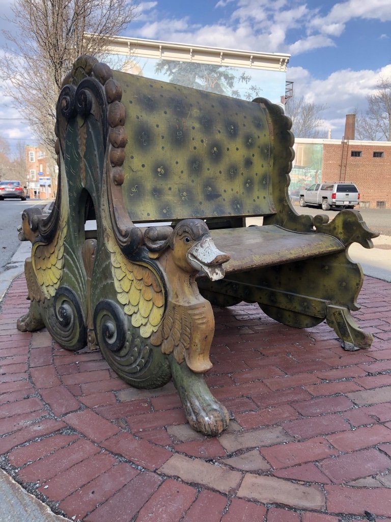 (19th c) CAROUSEL BENCH CARVED w/ DUCKS & SCROLLS: "#7" - Rare, whimsically carved back-to-back bench of shaped laminated wood screwed to ogee structural iron supports, fronted with carved and painted feathered ducks with glass eyes, frowns and scroll
