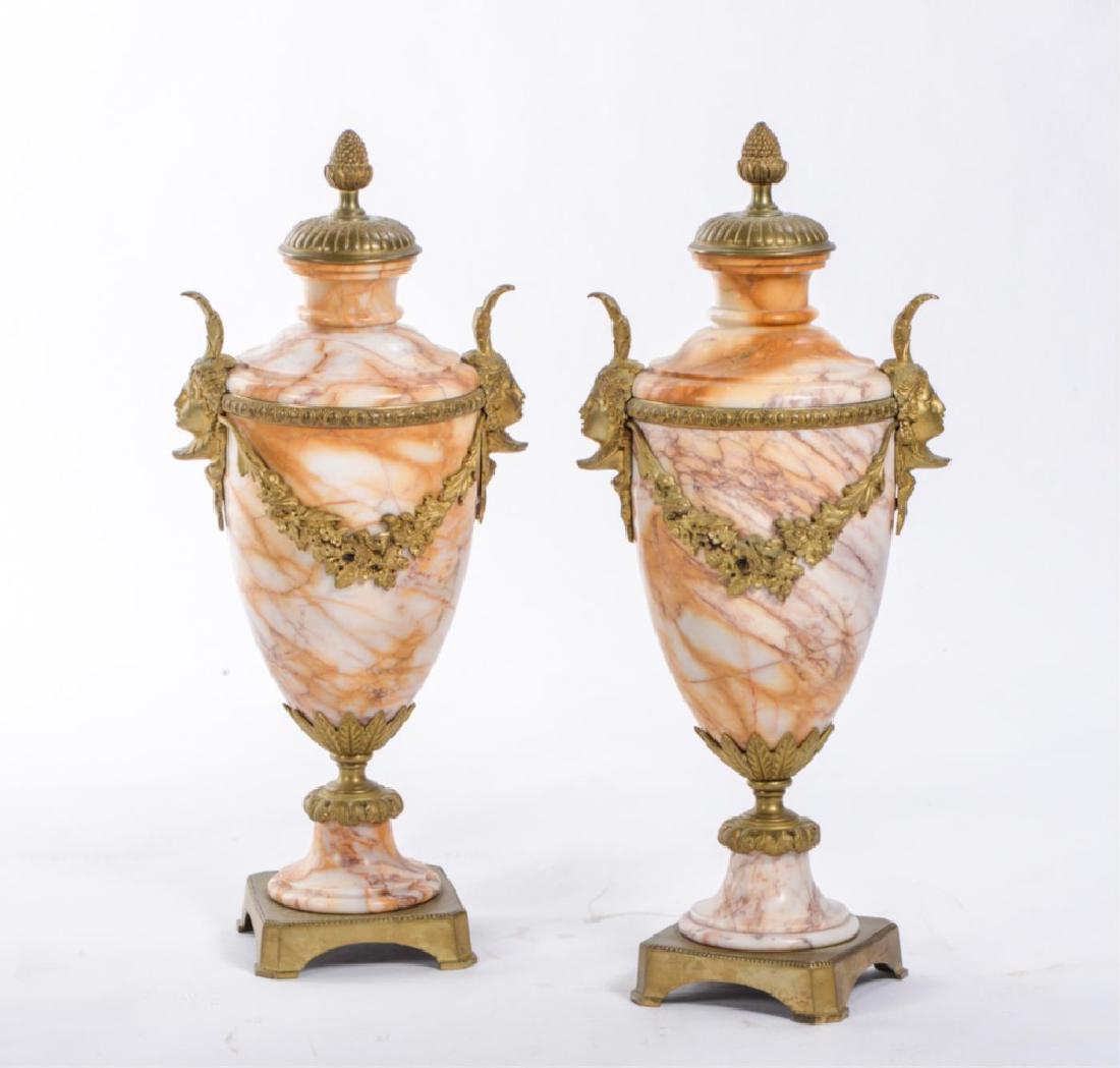 PAIR OF ONYX URNS WITH GILT FIGURAL ORMOLU MOUNTS: Classical vasiform urns mounted with fruit finial, goddess handles connected with egg and dart bands with swags of flowers and molded foot. unmarked. 17 inches.