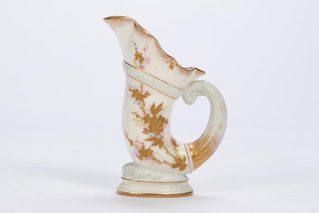 BELLEEK CORNUCOPIA-FORM MINIATURE VASE: Hand painted and raised gilt sprays of flowers.signed. 5 inches.