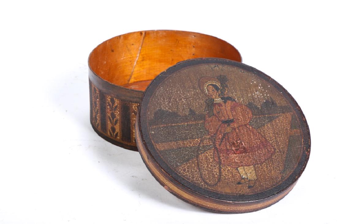 HIGHLY PAINT DECORATED ROUND PANTRY BOX: Depicting young girl with hoop in (19th c) dress. Sides decorated with alternating floral bands. 3 1/2 x 7 3/4 inches.