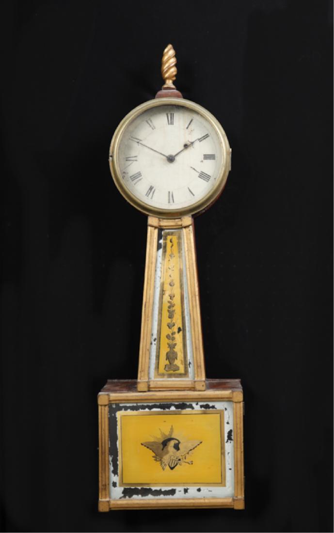 FEDERAL PERIOD BANJO CLOCK: Weight driven movement, case with gilt flame finial, 7 inch dial with Roman numerals, reverse painted and eglosime tablets with patriotic American eagle. 32 1/2 inches.