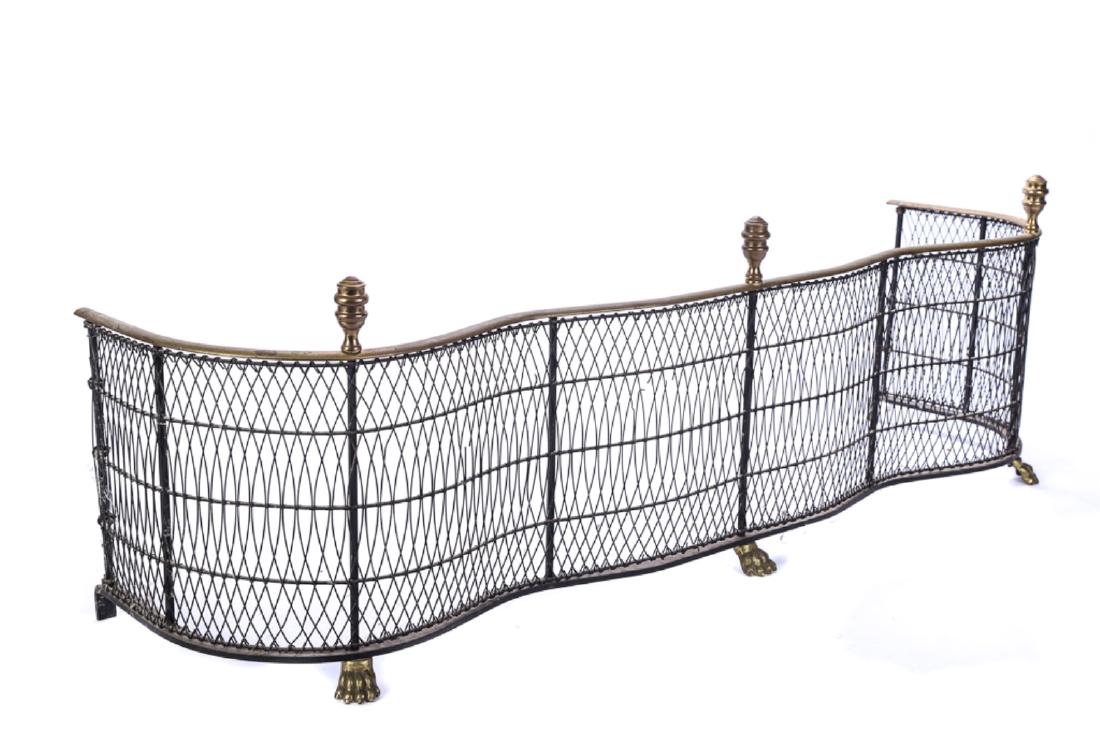 FEDERAL STYLE BRASS & WIRE FIREPLACE FENDER: Serpentine form with urn finials and lion paw feet. 16 x 49 x 15 inches
