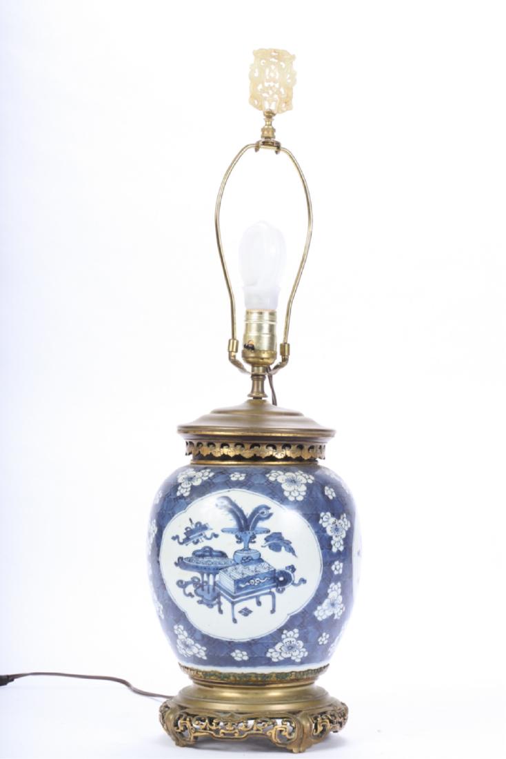CHINESE BLUE AND WHITE GINGER JAR LAMP: Pierced bronze base and cover with pieced jade? plaque finial. 16 1/2 inches (to top of socket). Plaque 2 1/2 x 1 7/8 inches.