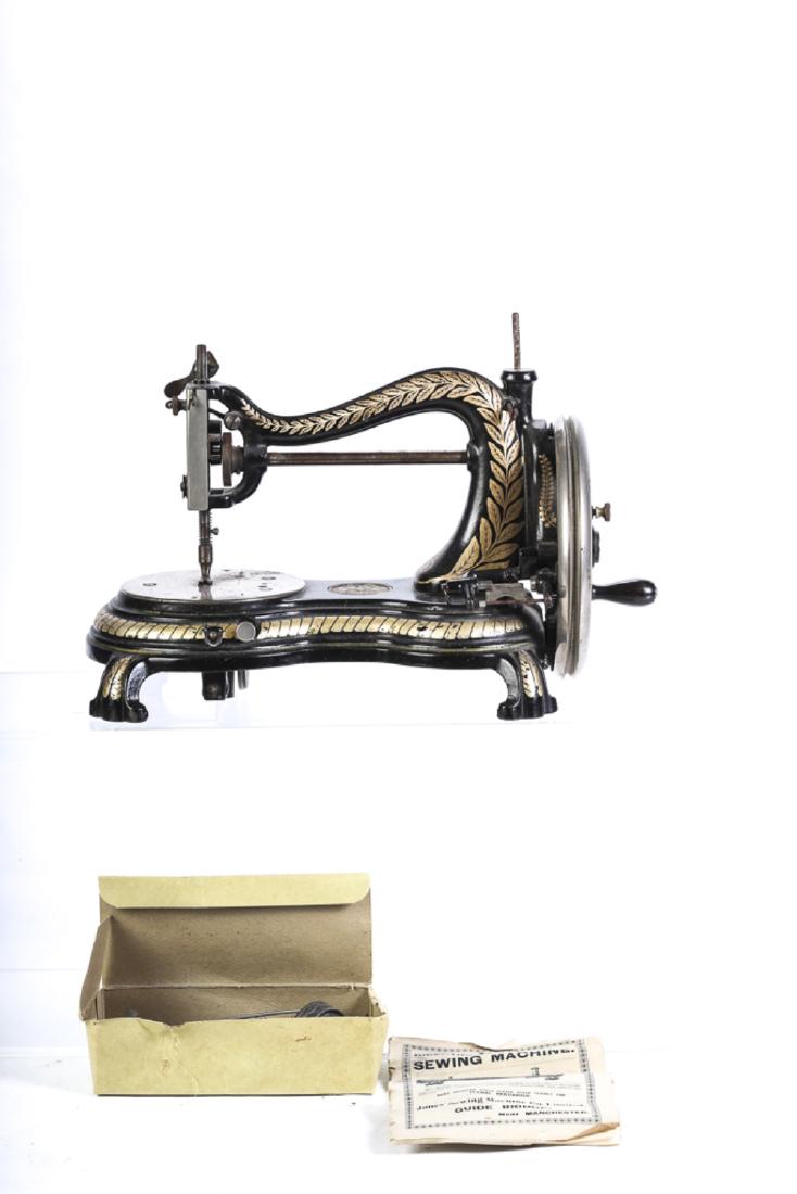 JONES' HAND MACHINE -DEMINUTIVE SEWING MACHINE: Together with the original directions for operation as well as a box of sewing machine accoutrements. 10 1/2 x 16 x 8 inches.