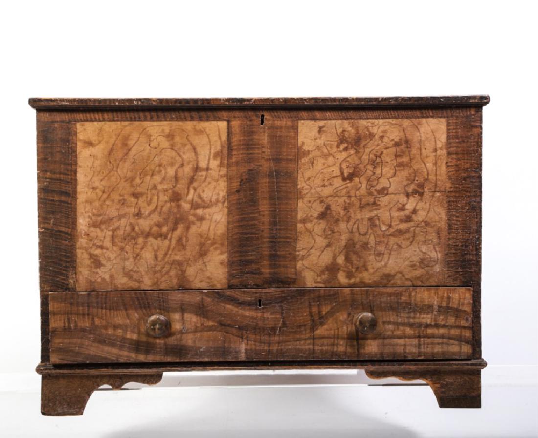 DIMINUTIVE GRAIN PAINTED ONE DRAWER BLANKET CHEST: Incorporating vinegar sponge and comb-work exterior with partially grained interior. Lower drawer interior with faux birdseye maple interior. Strap hinges and bracket feet. 25 x 36 1/2 x 18 inches.