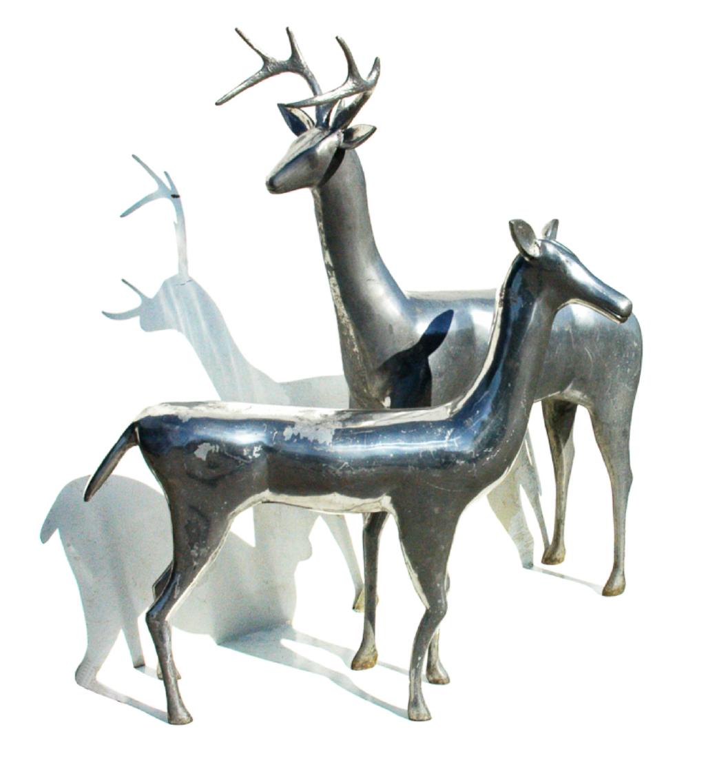 PAIR OF ART DECO CAST ALUMINUM DEER: FROM A NEW YORK CITY DEPARTMENT STORE CHRISTMAS DISPLAY; CIRCA 1930. Buck H 45”; L 34”; Doe H 34”; L 33”.