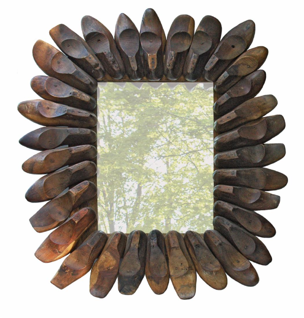 WHIMSICAL SHOE FORM FRAME WITH MIRROR GLASS: Late 19th-early 20th c. The frame composed of thirty-one old wooden shoe forms of varying sizes and styles. Shoe frame H 45”; W 37”; D 6”; mirror glass H 24”; W 16”.