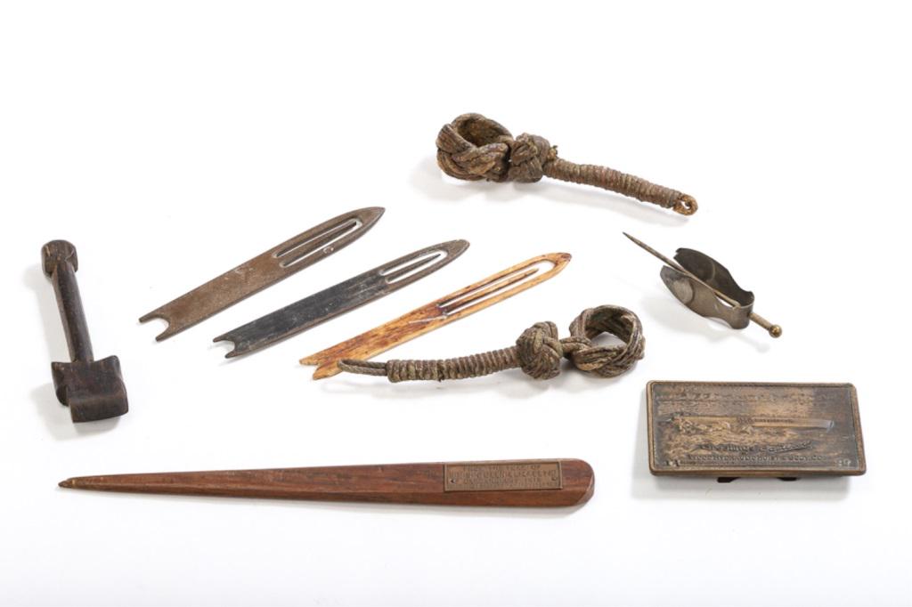 MISC LOT OF SAILOR ITEMS. 9 PIECES: Sailor items include 3 net shuttles(1Bone), wooden seam rubber, 2 knot work pieces and an unusual tool, Letter opener HMS Queen Elizabeth 1915, Desk plaque Garwood.