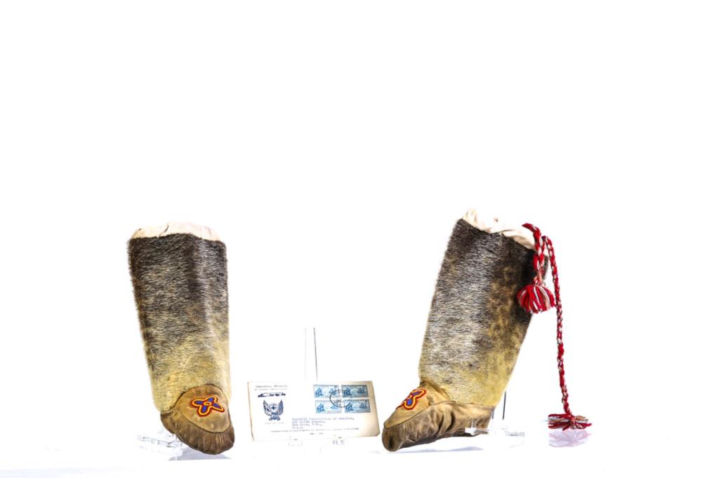 GRENFELL MISSION SEAL SKIN BOOTS & STAMP COVER: With colorful vamp beadwork and tassel pulls. 12 x 6 inches. Together with Grenfell Mission commemorative cover and 1941 block of cancelled Grenfell 1865-1940 Newfoundland 5 cent stamps. Provenance: B