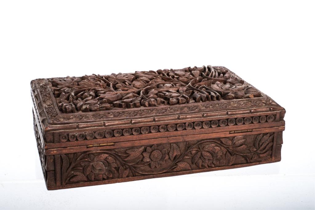 ANGLO INDIAN FLORAL CARVED CIGARETTE BOX: Deeply carved floral cover with, bamboo and concentric boarder. (4) sides are also floral carved over a stippled field. Top opens to interior with (3) divided compartments.