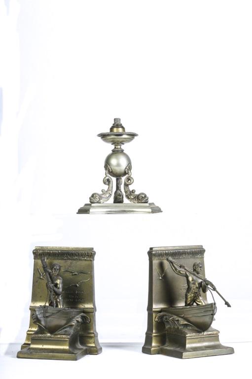 BOOK ENDS, DOLPHIN STAND 3 PIECES: 1) Brass book ends Harpooner at the ready, 1 harpoon damaged..2) Silver plate stand with dolphin footed base. Dolphins are very well done, 6 1/2" tall.