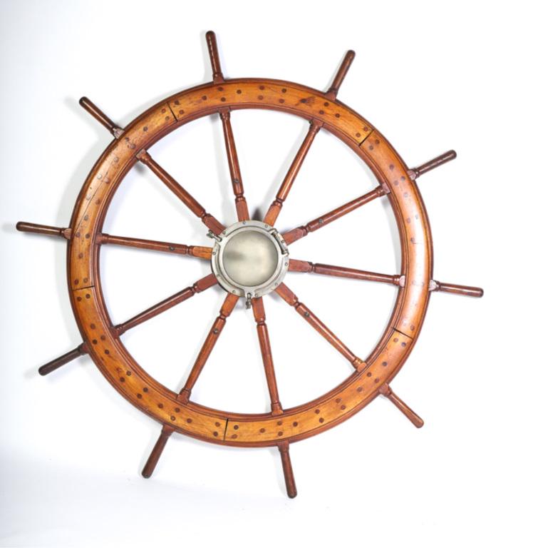 LARGE MAHOGANY SHIP'S WHEEL: Turned spokes and porthole center. 67 inches (overall)