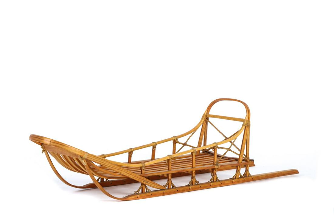 MODEL SLED: Well made model of a dog sled. Constructed of wood with sinew ties. Model is 20" and in excellent Condition.