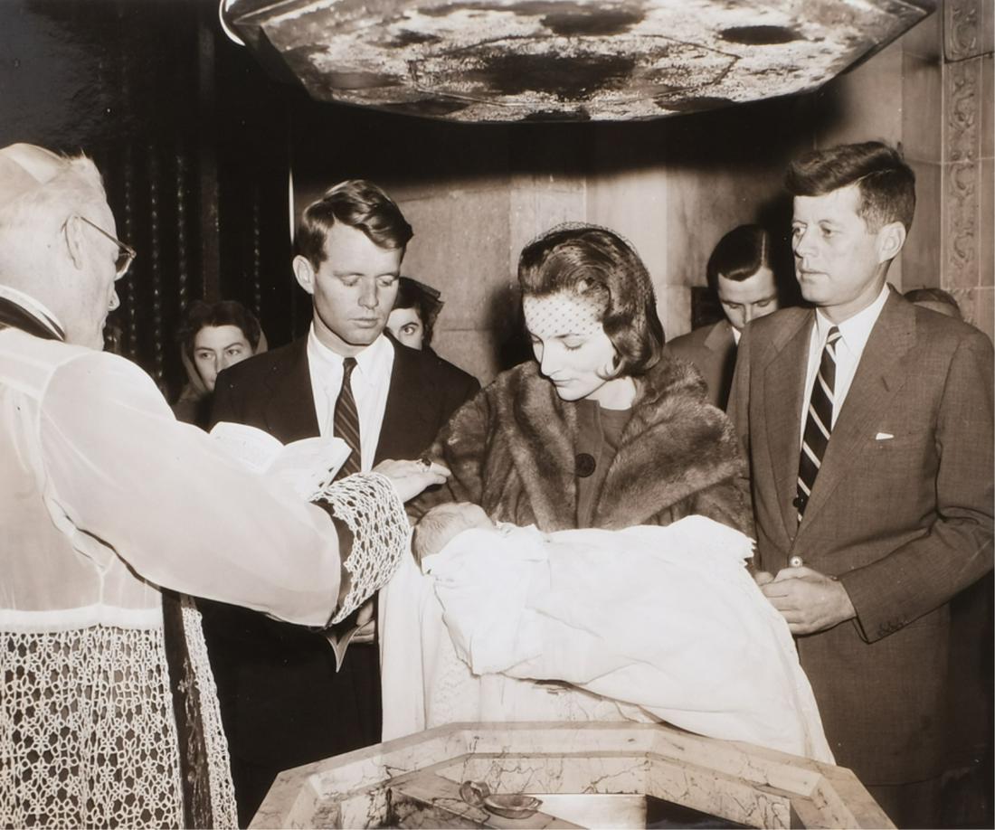 CHRISTENING OF CAROLINE KENNEDY DEC. 13th, 1957: Black and white photograph of John Kennedy, Robert Kennedy and Lee Radziwell (Jackie's sister) holding Caroline. Archbishop Cushing of Boston, Robert Kennedy and others in background. A second photogr