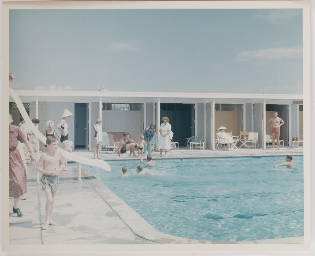 PRESIDENT KENNEDY in POOL w/ JOHN JOHN & JACKIE: John John is being encouraged to jump into his father's arms in the pool at Baileys Beach in Newport RI with Jackie (in sun hat and hands on hips) looking on with nanny, Janet (with towel) and Yusha.