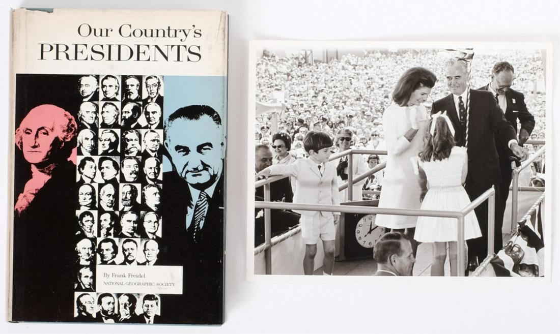 JACKIE, JOHN & CAROLINE KENNEDY CHRISTENING SHIP: USS John F. Kennedy, Newport, News Virginia with President Johnson behind John John. by Newport News and Dry Dock Company 5/27/67. 8 x 10 inches, "Our Country's Presidents" by Frank Freidel published 