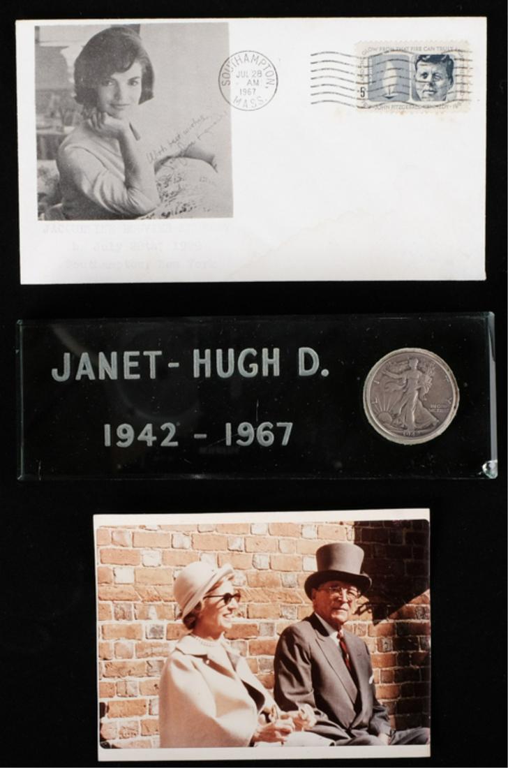 HUGH & JANET AUCHINCLOSS 25th WEDDING ANNIVERSARY: (1) Glass plaque engraved "Janet- Hugh D. 1942-1967" and set with a Walking Liberty silver 25 cent piece., (1) color photograph of Hugh and Janet, (1) mailed cover envelope with photograph of Jackie c