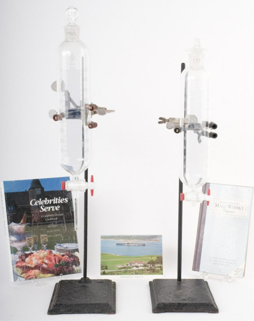 YUSHA'S WHISKEY DISPENSERS FOR HIS BAR: (2) Burettes with stands used by Yusha to dispense Auchentoshan Single Malt Scotch Whiskey (known to be Yusha's staple.) Together with: "Michael Jackson's Malt Whisky Companion" inscribed by Yusha, "C