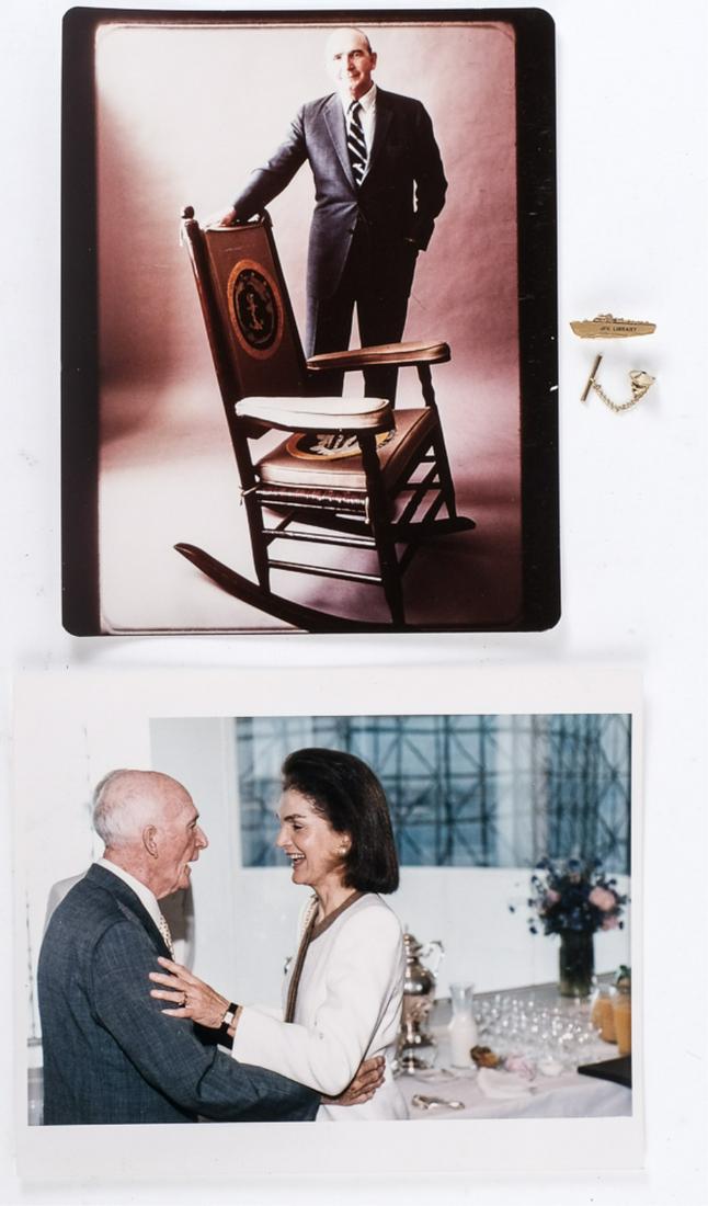 DAVE POWERS and JACKIE KENNEDY at JFK LIBRARY: and Dave Powers standing beside John F. Kennedy's rocking chair. 8 x 10 inch color photographs. Together with a JFK Library PT 109 tie tack. Provenance: Dave Powers Special Assistant to the President.