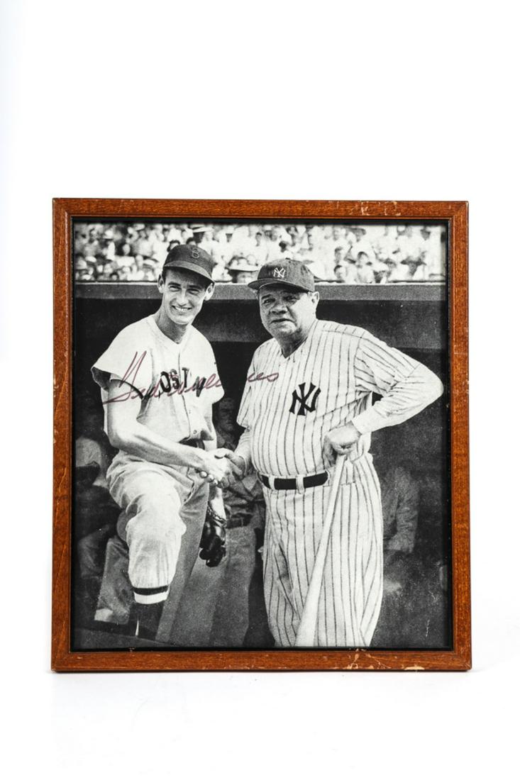BOSTON RED SOX TED WILLIAMS SIGNED PHOTOGRAPH: Ted Williams shaking hands with Babe Ruth Fenway Park July 14, 1943 10 x 8 1/2 inch photomechanical print signed by Ted Williams with a felt tip marker. framed. Provenance: From the estate of Arthur M
