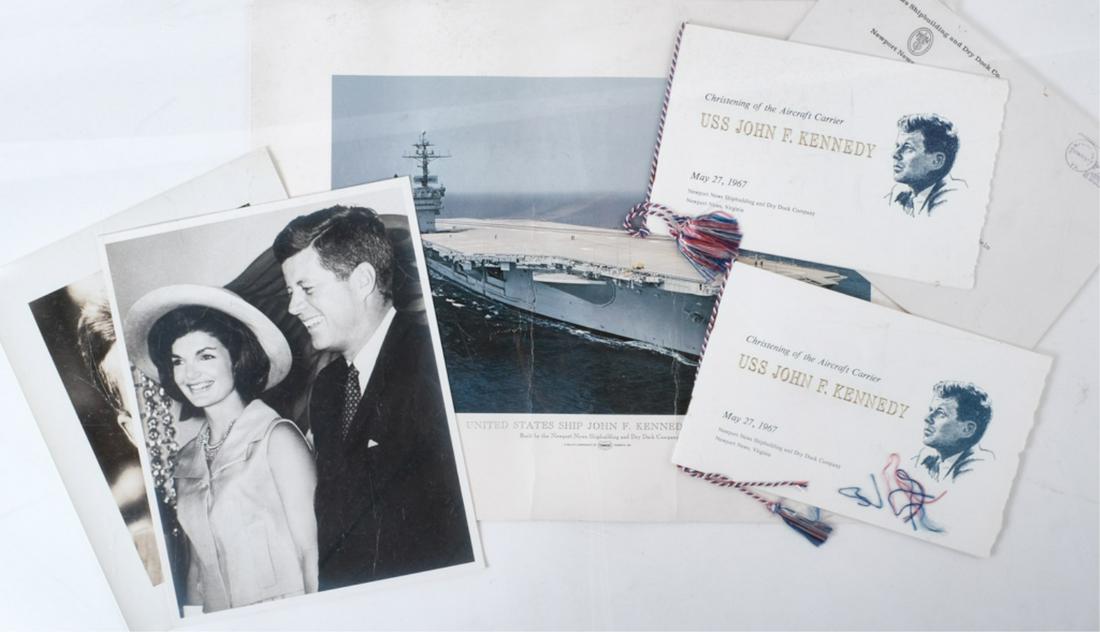 CHRISTENING OF THE USS JOHN F. KENNEDY: (2) "Christening of the Aircraft Carrier USS John F. Kennedy" pamphlets saddle-bound with a patriotic tassel, (2) 8 x 10 inch black and white photographs of J.F.K. and Jackie and colored print of the 