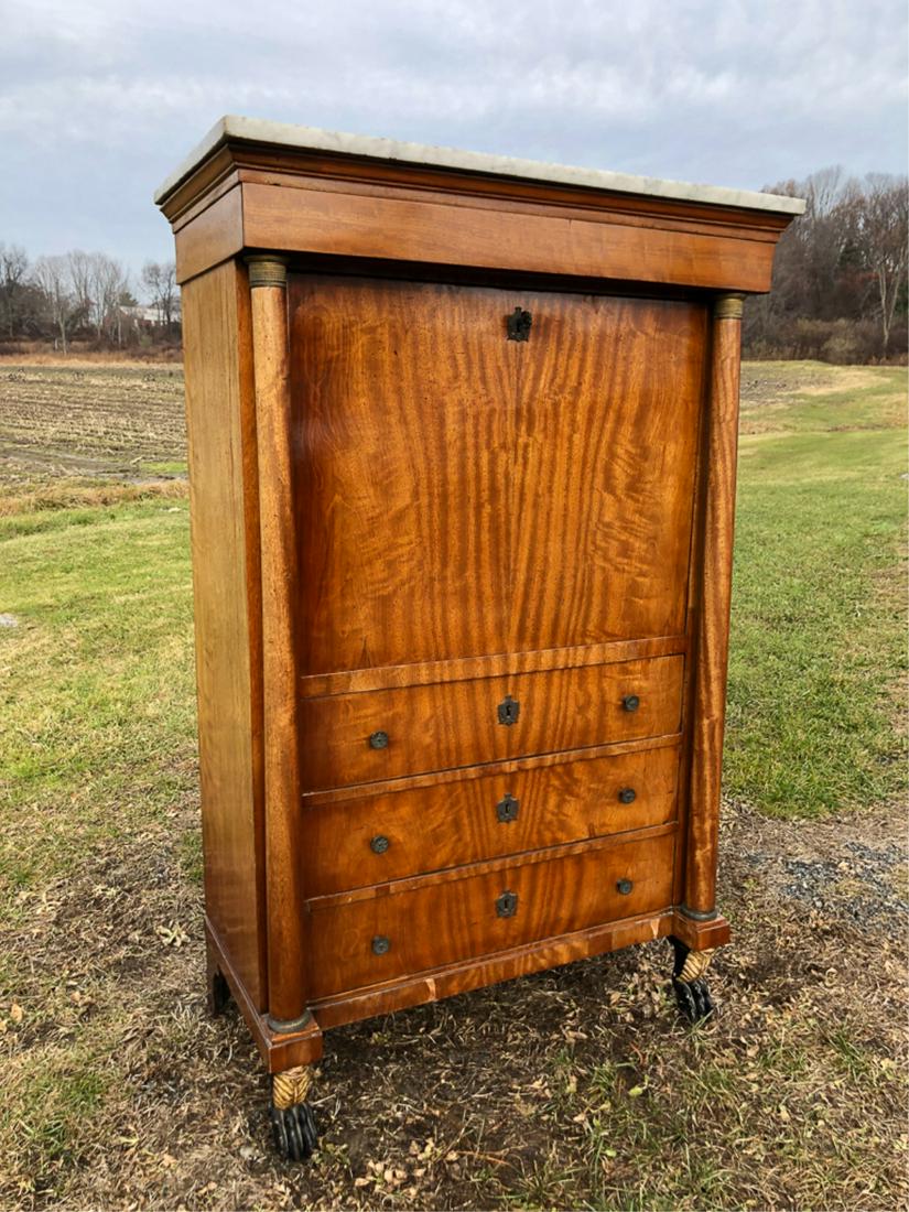 FRENCH EMPIRE MAHOGANY FALL-FRONT DESK: Marble top, fall front opens to an array of drawers and pigeon holes and nicely framed by columns with bronze capitals above (3) drawers. Ebony lion paw feet. 60 1/4 x 38 1/4 x 20 inches