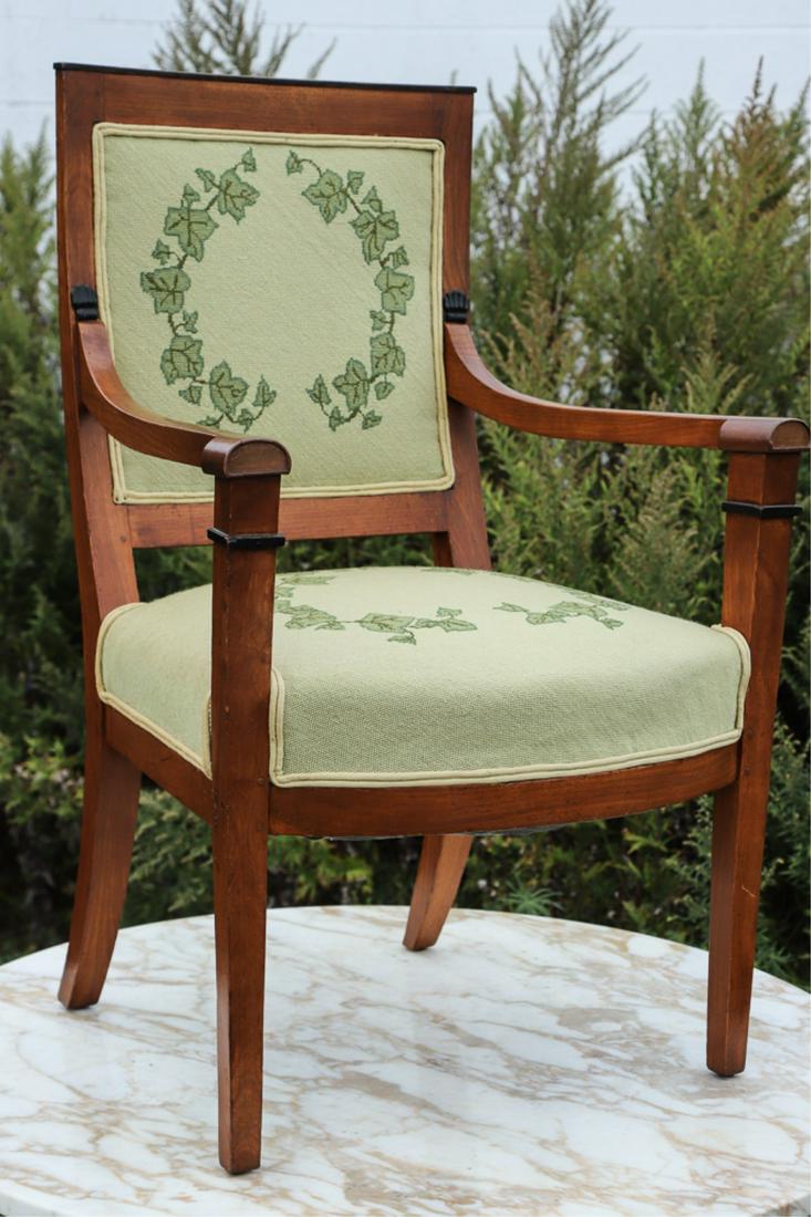 (19th c) BIEDERMEIER UPHOLSTERED ARMCHAIR: Ebony painted crest rail and accents. Ivy embroidered seat and back. 35 x 22 1/2 x 24 inches