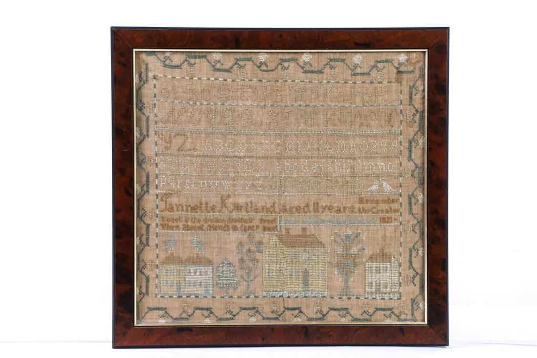 JANNETTE KIRTLAND SAMPLER DATED 1821: Alpha-numeric sampler with running strawberry boarder, signed Jannette Kirtland aged 11, and verse above houses with birds nestled between trees. silk on linen. framed 18 1/2 x 19 1/2 inches (overall)