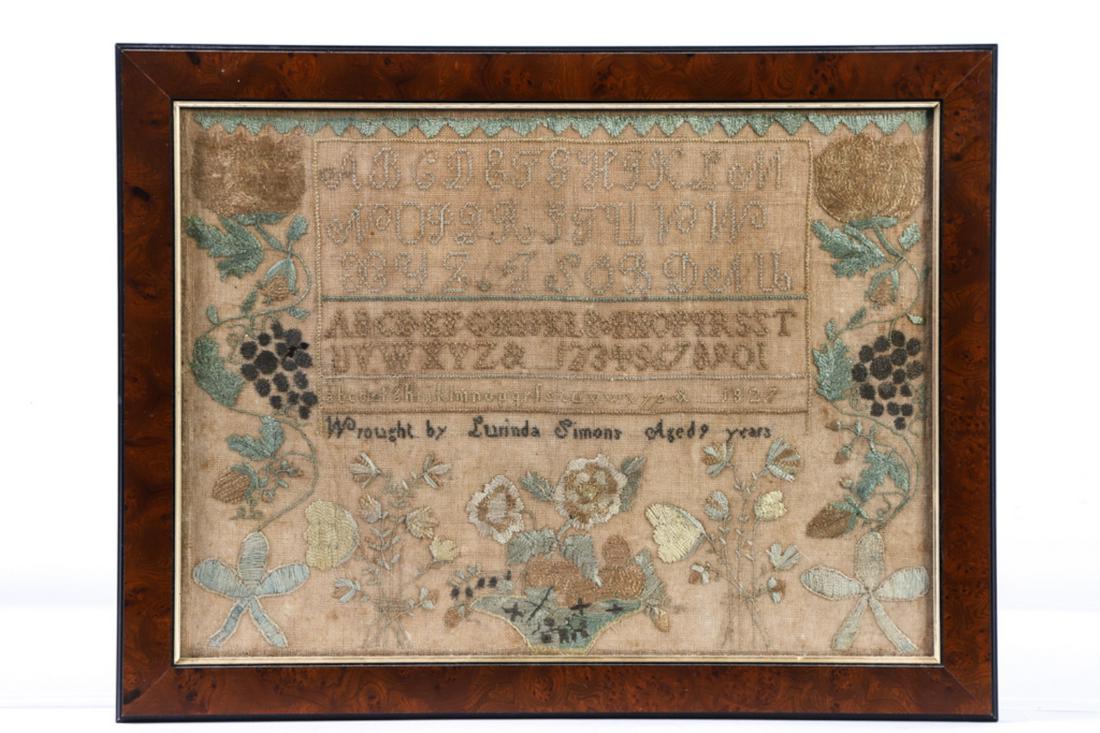LURINDA SIMONS SAMPLER DATED 1827: Alpha-numeric sampler with diamond border, bold flowers, grapes, strawberries, cut flowers and basket of flowers. silk on linen. framed 15 x 19 1/2 inches (overall)