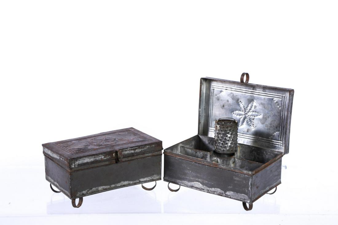 PAIR OF PENNSYLVANIA WRIGGLEWORK TIN SPICE BOXES: Punched floral lids open to interior divided into (5) compartments. (1) Center compartment includes a nutmeg grater. Each raised on delicate hoop feet. 3 x 6 x 4 inches.
