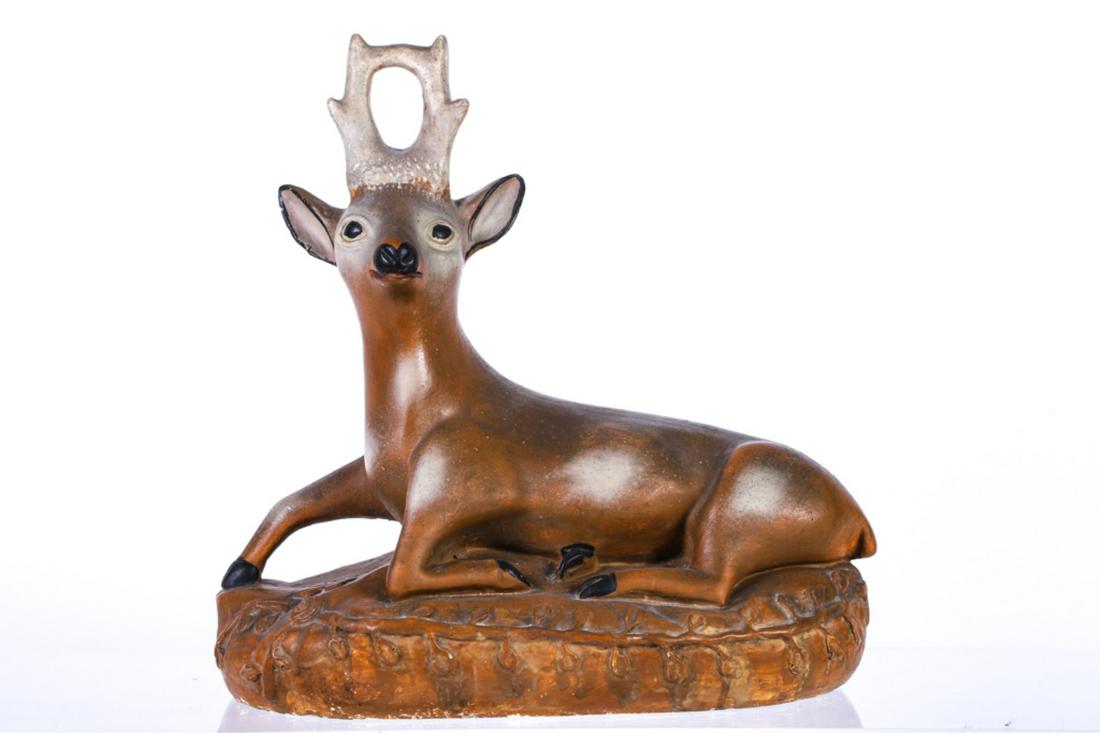 PENNSYLVANIA CHALKWARE DEER: Recumbent deer resting on a bed of leaves and clover. 17 x 17 x 7 inches.