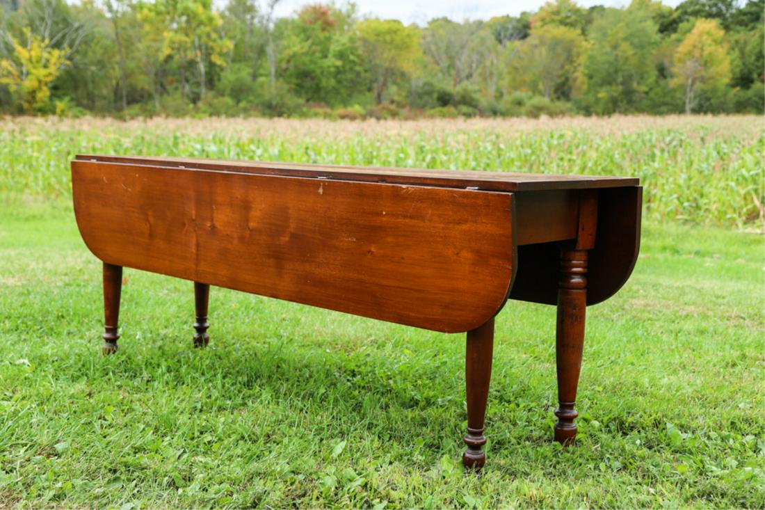 MAPLE DROP LEAF HARVEST TABLE: Pegged apron and turned legs. 28 1/2 x 72 x 20 inches. / 45 inches with leaves up.