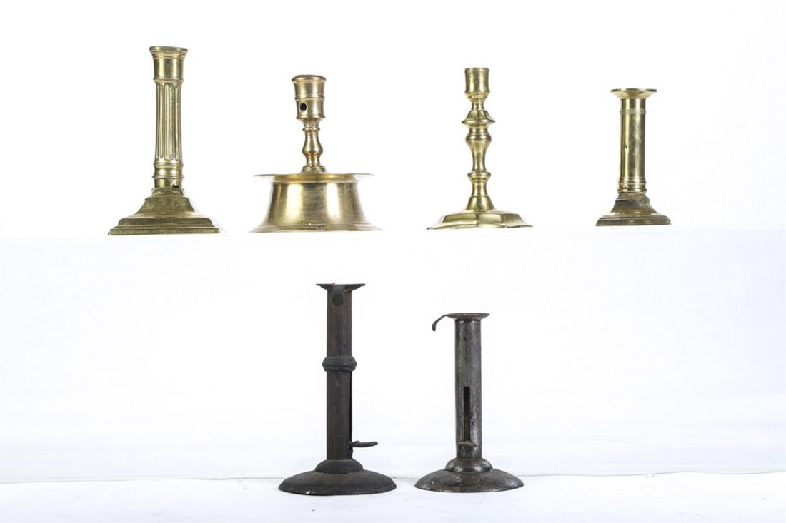 ASSORMENT OF (6) SINGLE CANDLESTICKS: Including: Wedding band push-up hog scraper, push-up hog scraper with chair hook, (2) neo-classical brass examples and (2) early reproductions. 7 1/4 inches (and under)