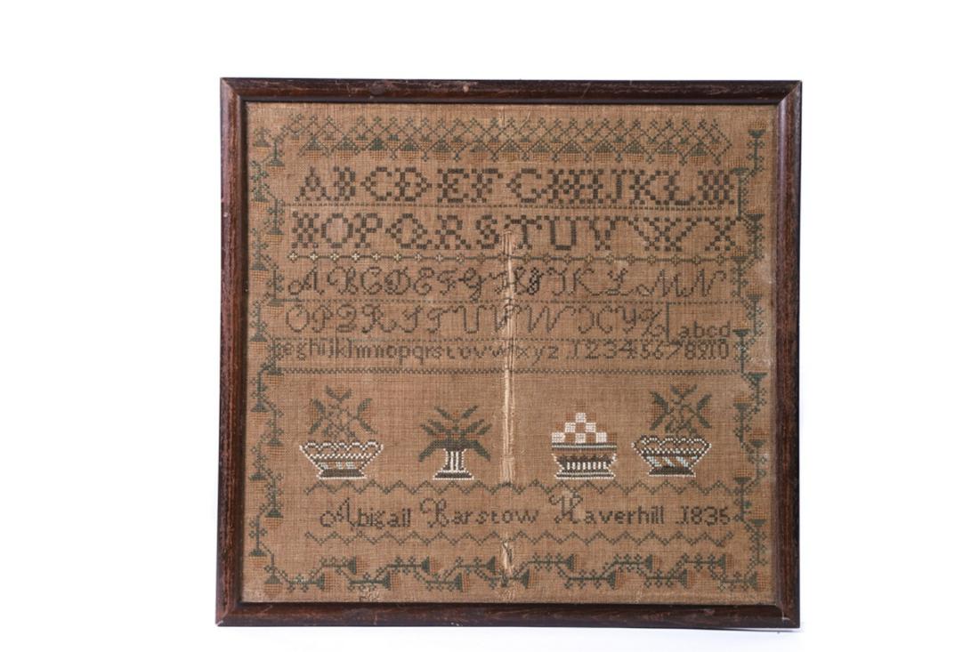 SAMPLER by ABIGAIL BARSTOW of Haverhill 1836: Alphabet sampler with running strawberry border, and baskets of fruit and flowers. silk on linen. framed 18 1/4 x 19 1/2 inches