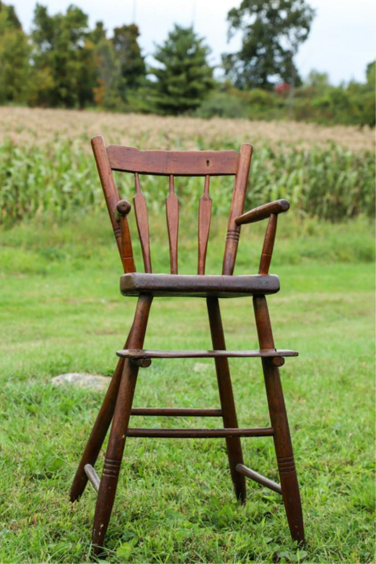 ARROWBACK WINDSOR HIGH CHAIR: Turned maple with shaped pine seat. Remnants of early green wash. 34 x 17 x 16 inches.