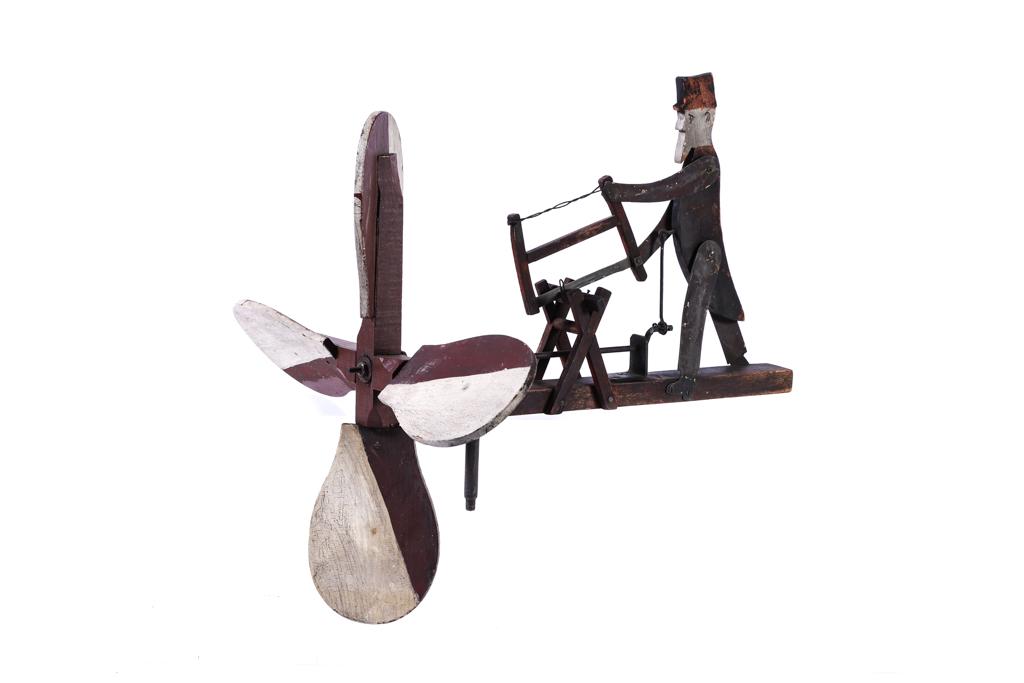 EARLY WHIRLIGIG of UNCLE SAM SAWING WOOD: Carved and painted wood and brass. 16 x 15 x 15 inches.