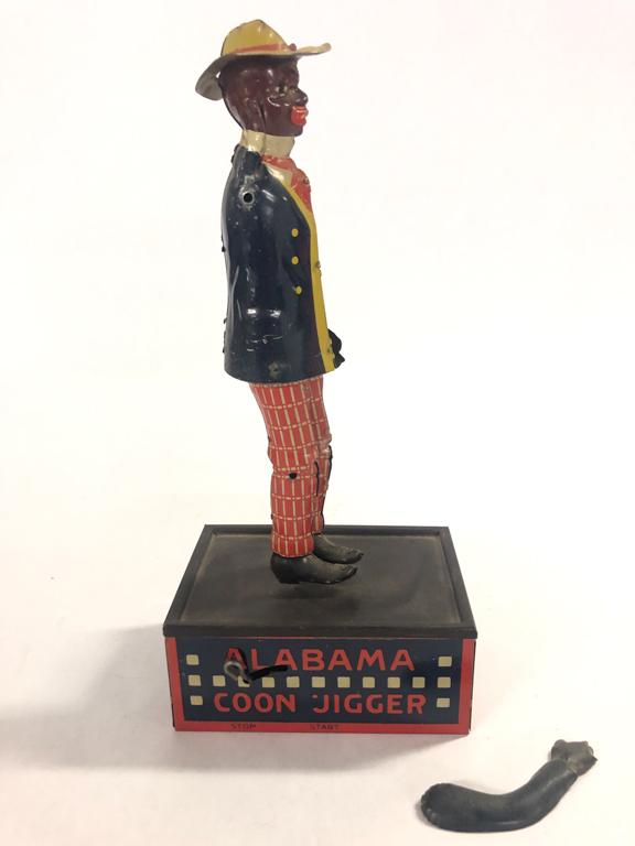 VINTAGE TIN TAMBO ALABAMA COON JIGGER WIND UP TOY: One are detached but present. By Ferdinand Strauss Co. 10" From the collection of former FBI agent Bill Rosenbaum Condition: See photos Temp No 3122