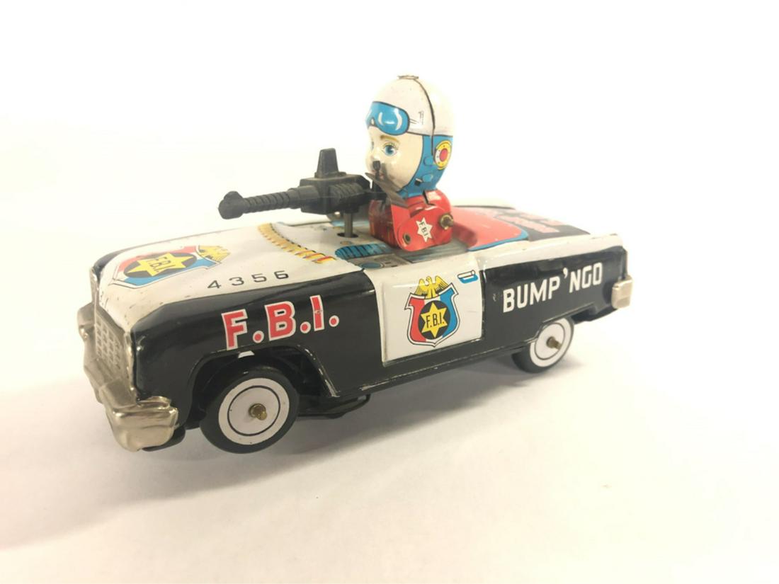 VINTAGE BUMP'NGO FBI CAR: By K.O. made in Japan. Wind up in working condition. Minor scattered scratches 6 3/4" long From the collection of former FBI agent Bill Rosenbaum Condition: See photos Temp No 415