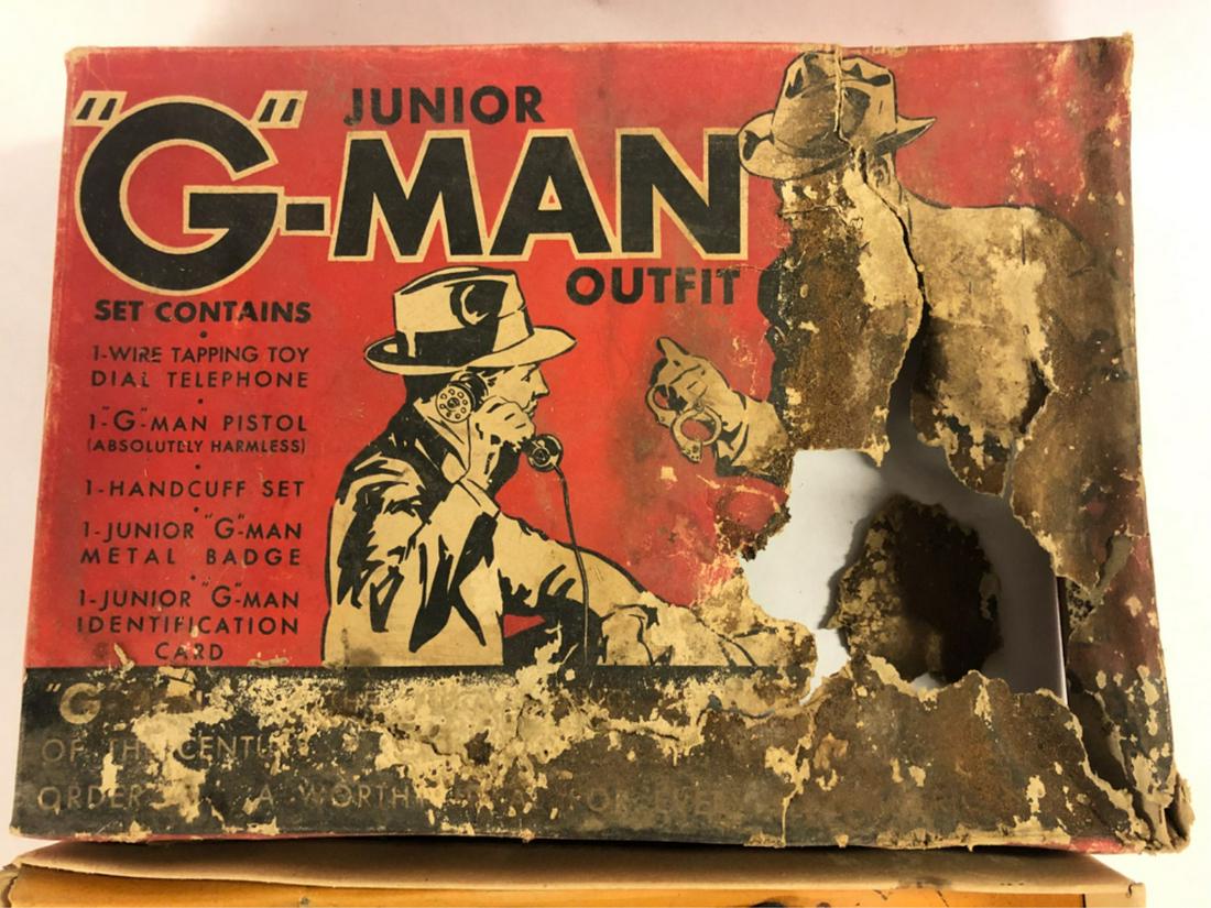 JUNIOR "G"-MAN OUTFIT: By Wyandotte Toys. Contains wire tapping toy dial telephone, "G"-Man toy pistol, handcuff set, metal badge, Junior "G"-Man identification card in original box (box top has a large hole on right hand s