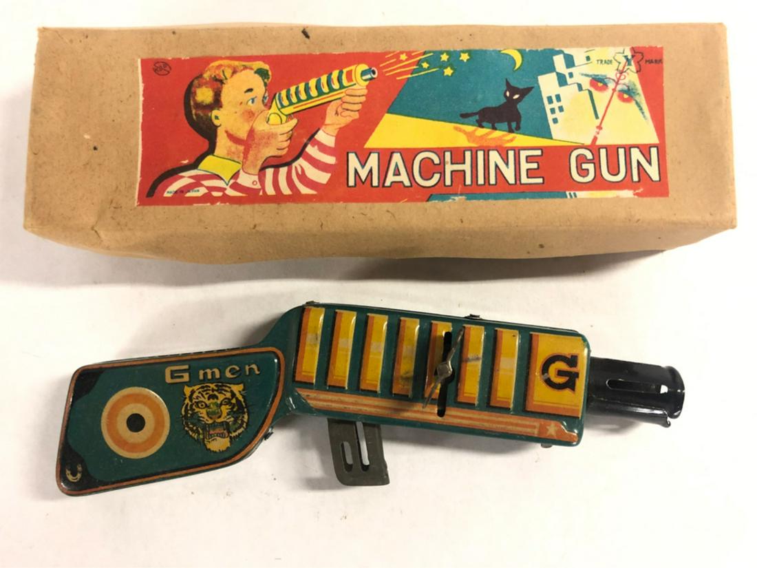 VINTAGE TIN LITHO G MEN TO MACHINE GUN: G Men and tiger litho on tin wind up machine gun in original box. Made in Japan by "Y" toys. 7 3/4" From the collection of former FBI agent Bill Rosenbaum Condition: See photos Temp No 491