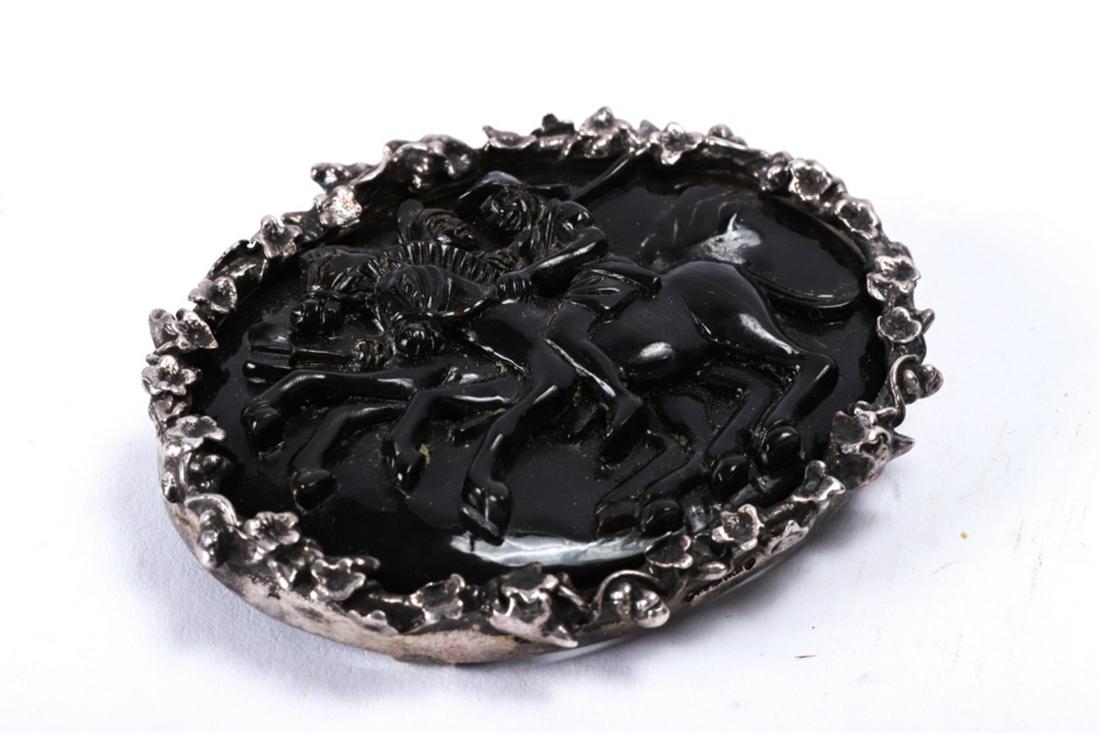 STEPHEN DWECK STERLING SILVER BROOCH: Plaque with men on horseback is mounted to sterling silver floral bezel. signed. 2 x 2 1/2 inches.