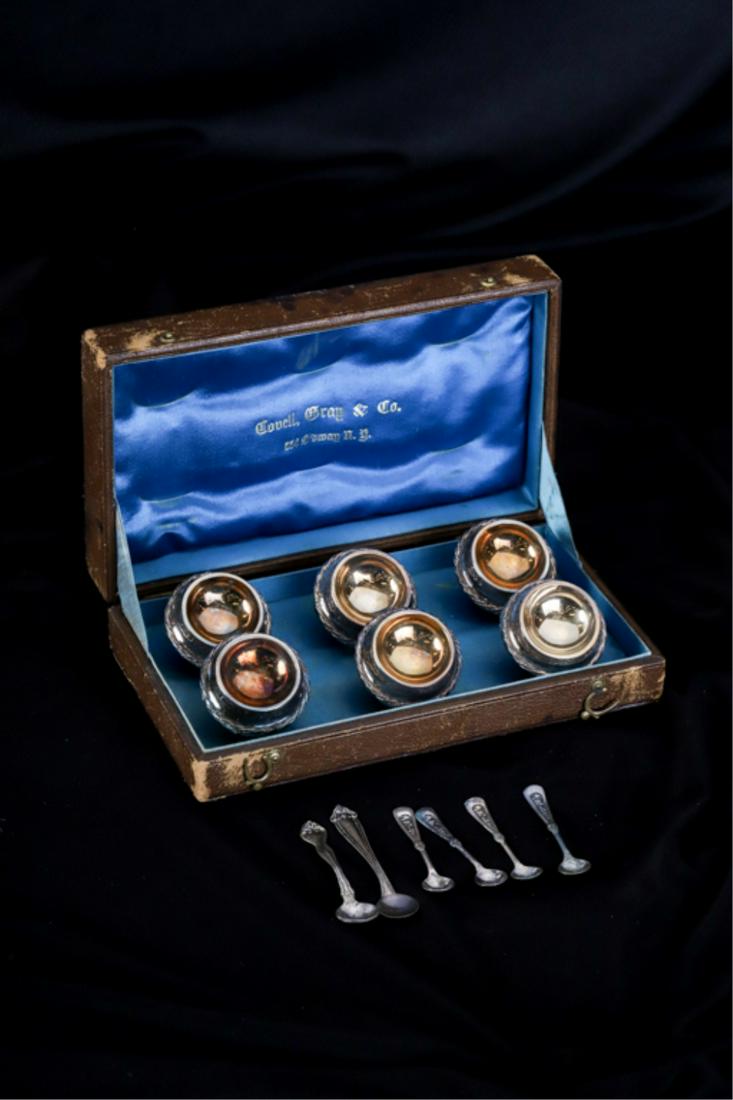 SET OF (6) STERLING GEORGE SHARP SALT CELLARS: in the original box retailed by Covell, Gray and CO with (6) sterling salt spoons. 1 5/8 inches. 3.53 ozt