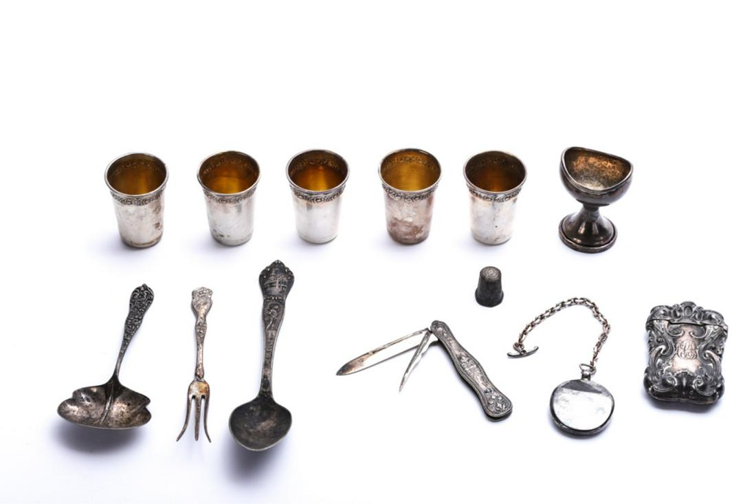 GROUPING OF STERLING SILVER OBJECTS OF VIRTUE: Including: English footed cup, (5) spirits cups embossed with a band of flowers, Hotel Plaza Athenee Paris fob on chain, art nouveau match case, pen knife, Old State House souvenir spoon, olive fork, 