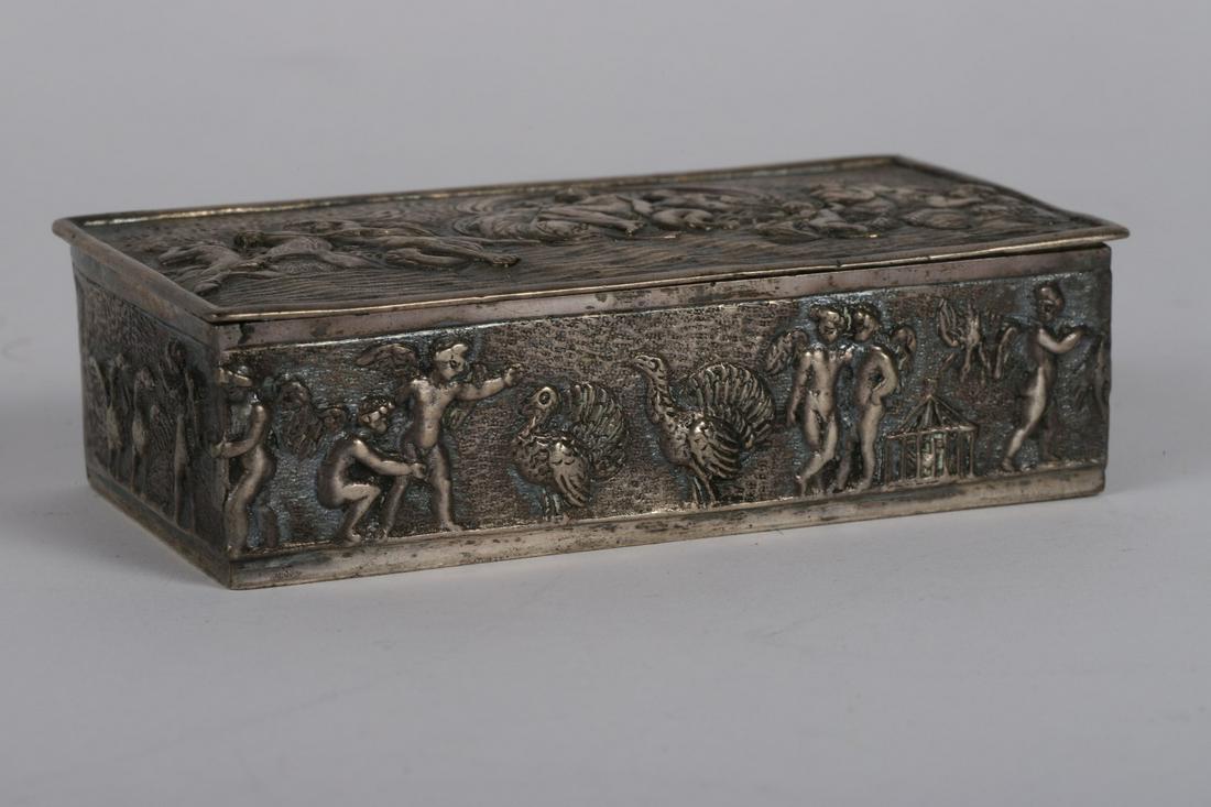 GERMAN SILVER REPOUSEE BOX with AMPHITRITE: Seated on a throne amongst cherubs, serpents and maidens. The sides depict cherubs and geese. marked 800. 1 x 4 x 2 inches Together with a reproduction of a silver Thaler coin. 4 troy ounces