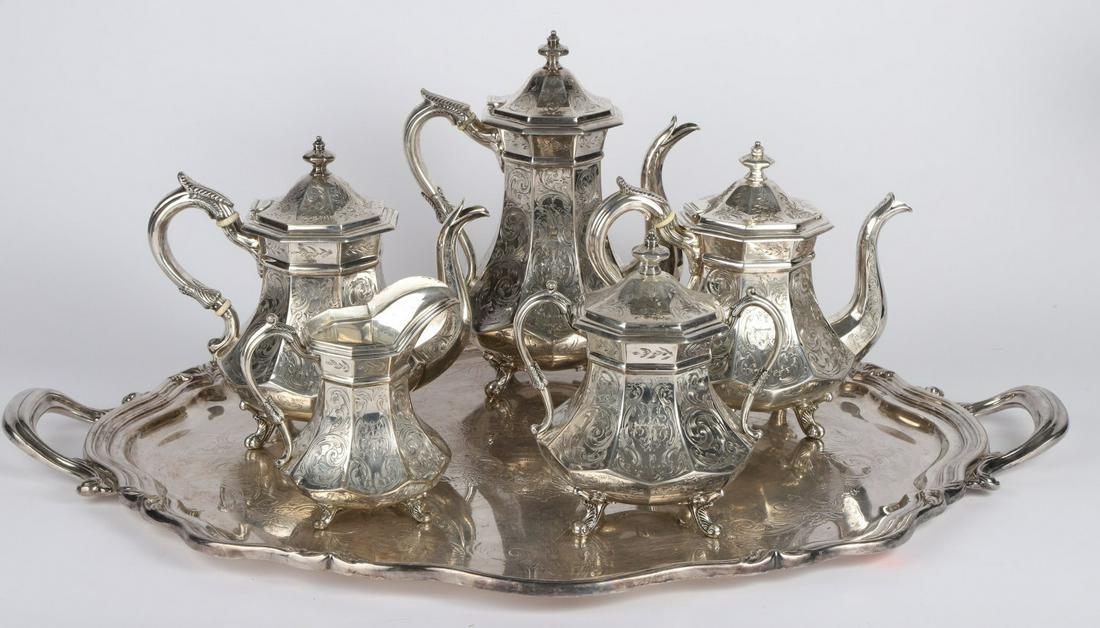 LINCOLN & REED (5) PIECE COIN SILVER TEA SET: Octagonal footed tea set engraved with acanthus leaves Including: Coffee Pot, (2) tea pots, creamer and sugar. signed. 134.7 troy ounces. Together with a silver plated tray 21 1/2 x 29 1/2 inches.