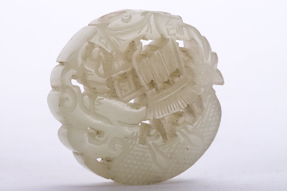 CHINESE CARVED & PIERCED WHITE JADE PLAQUE: Depicting a coastal landscape with figures and pagodas. 1 3/8 inches